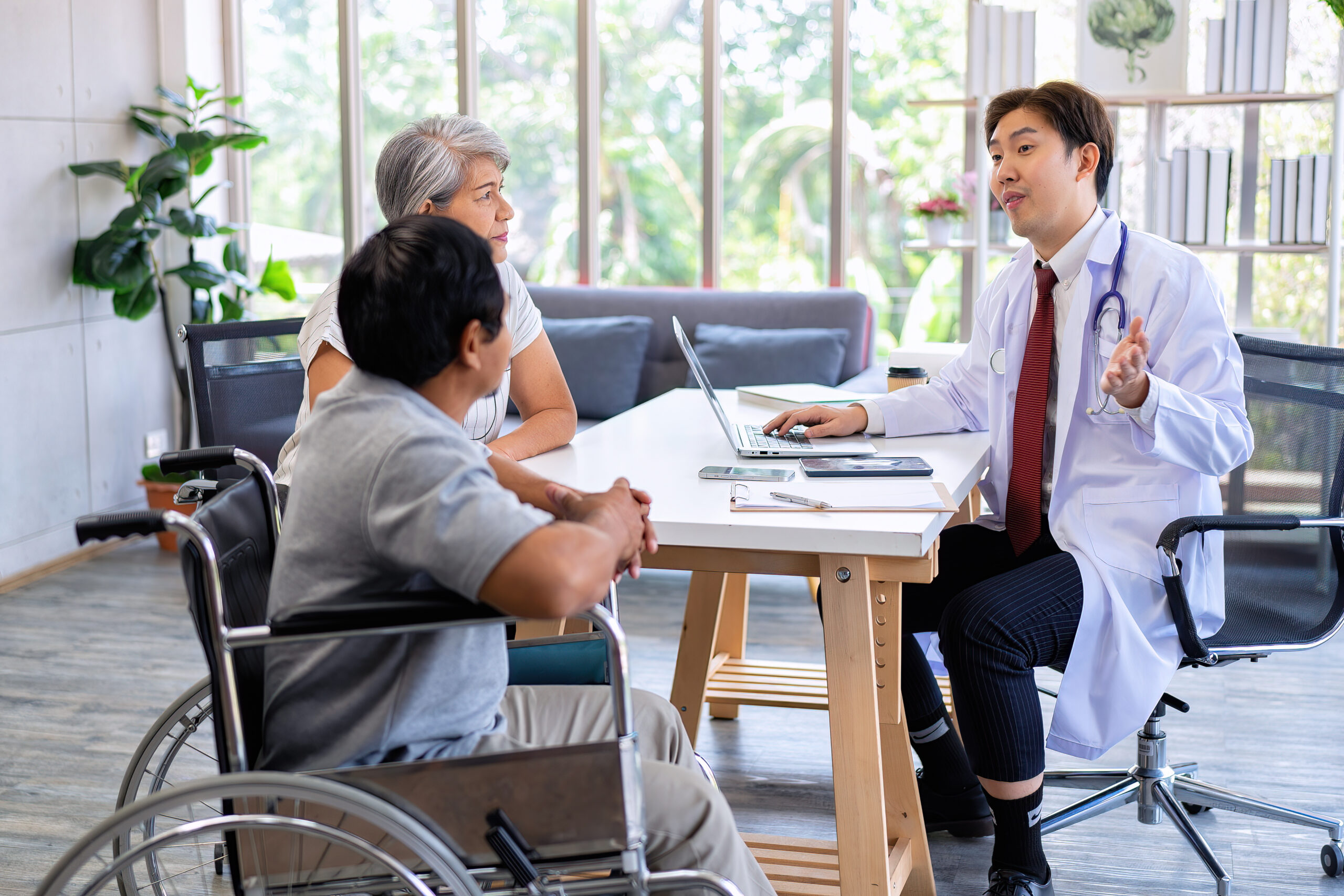Senior couple male on wheel chair having consultations with doctor for their sickness at clinic - Alabama Hospice and Palliative Care Organization